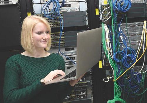 Female working on a computer in a computer server room